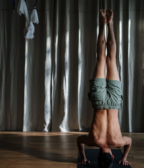Man in a deep stretching pose, showing flexibility and focus.